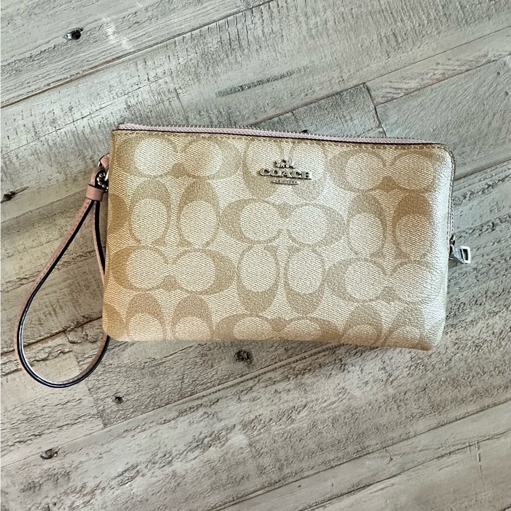 Coach, natural color with light pink trim wristlet purse